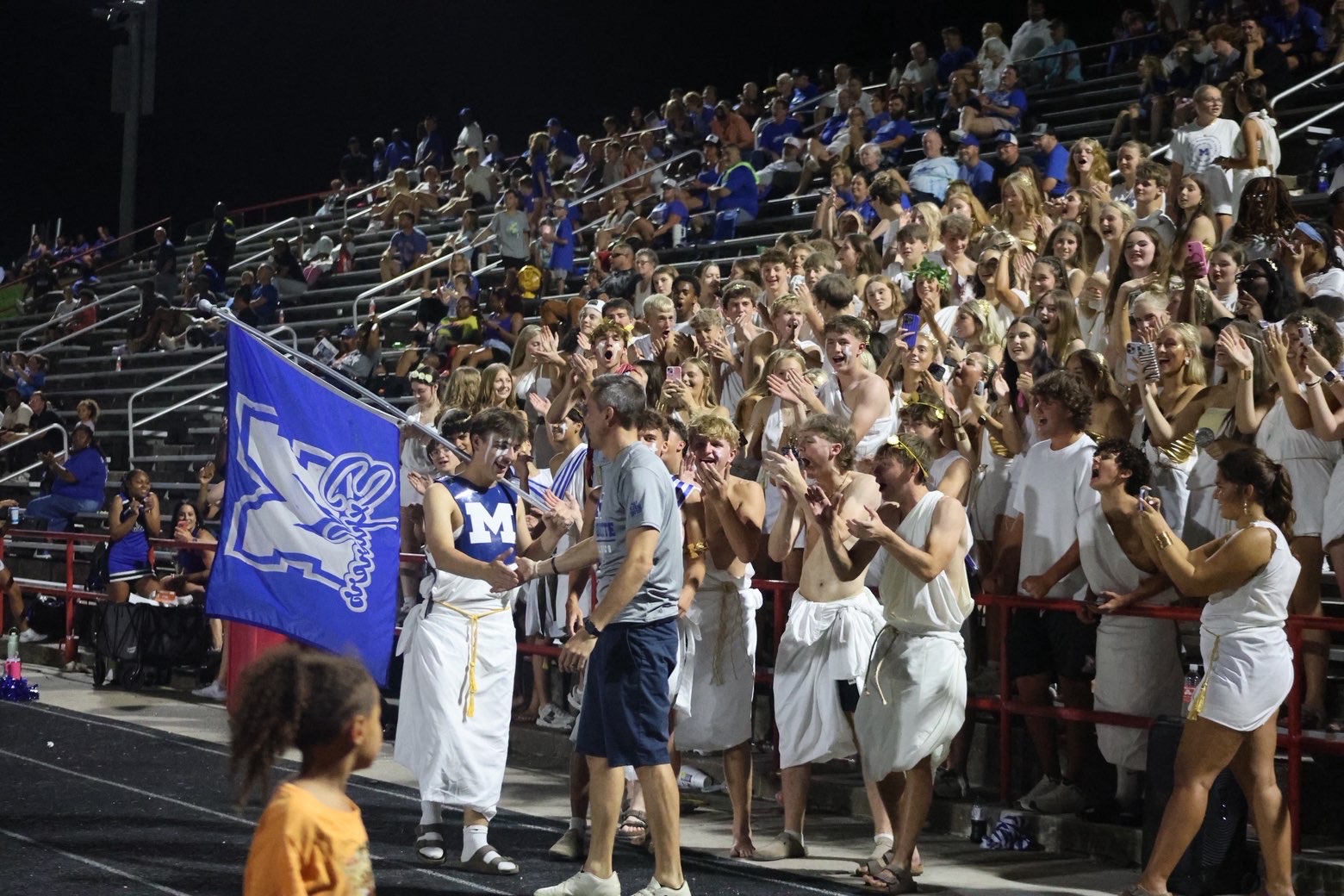 Captain Marquette (Eli Baggio) shaking Principal Tim Harmon's hand at the September 4th Football Game. Photo courtesy of Emma Hough.